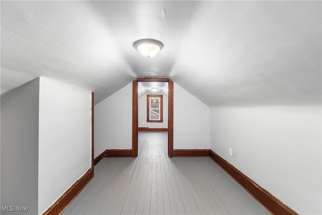1862 17th St SW, Akron, OH 44314 - additional living space with hardwood / wood-style flooring, lofted ceiling, and baseboards