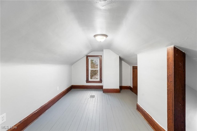 1862 17th St SW, Akron, OH 44314 - additional living space featuring hardwood / wood-style floors, lofted ceiling, and baseboards