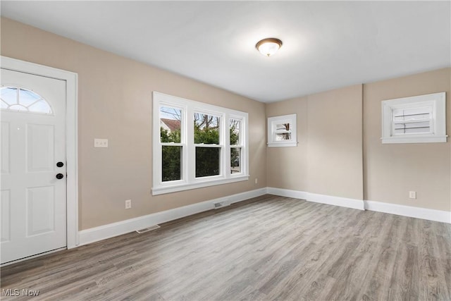 1862 17th St SW, Akron, OH 44314 - entrance foyer featuring baseboards, visible vents, and wood finished floors