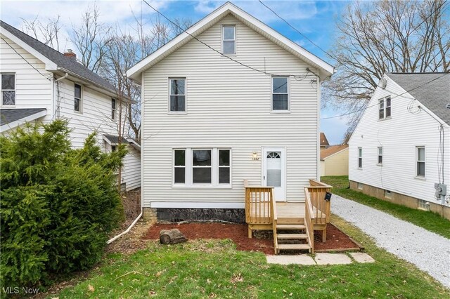 1862 17th St SW, Akron, OH 44314 - back of property featuring a lawn and a wooden deck