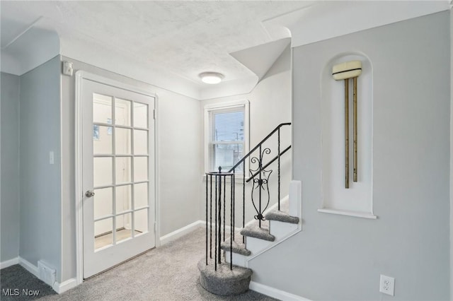 entryway featuring baseboards, visible vents, and carpet