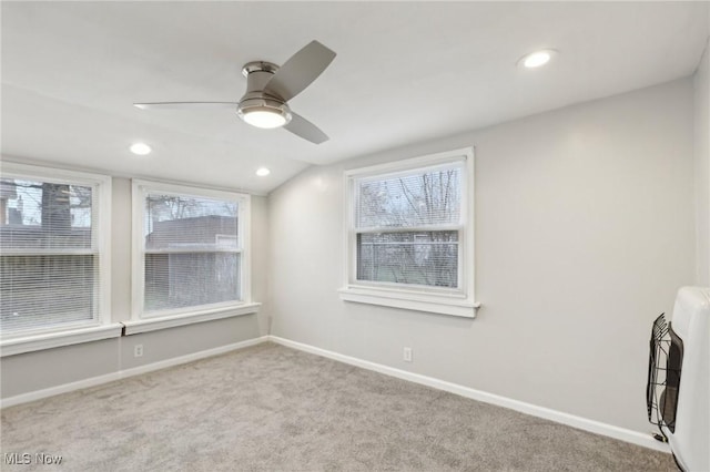 unfurnished room featuring baseboards, carpet floors, lofted ceiling, and a healthy amount of sunlight