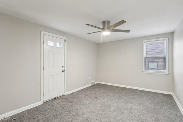 unfurnished room featuring baseboards, visible vents, ceiling fan, and carpet floors
