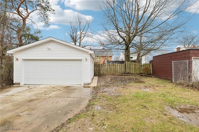 detached garage featuring fence