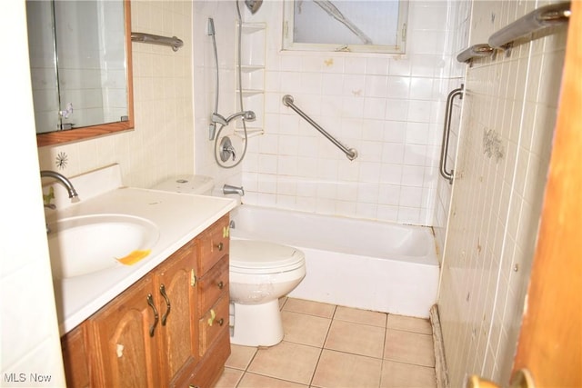190 10th St, Campbell, OH 44405 - bathroom with tile patterned floors, toilet, vanity,  shower combination, and tile walls