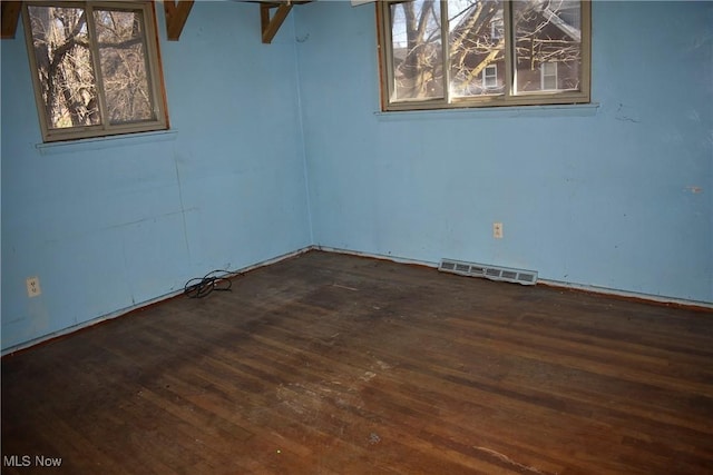 190 10th St, Campbell, OH 44405 - empty room featuring visible vents and wood finished floors