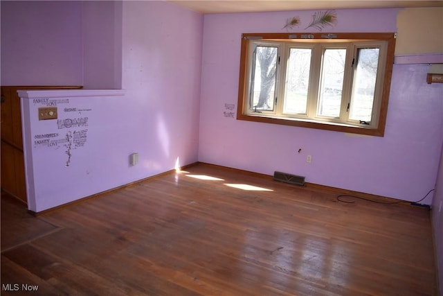 190 10th St, Campbell, OH 44405 - spare room with wood finished floors and visible vents