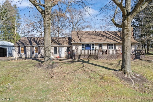 back of house featuring a yard and a deck