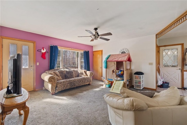 living room with baseboards, carpet flooring, and a ceiling fan