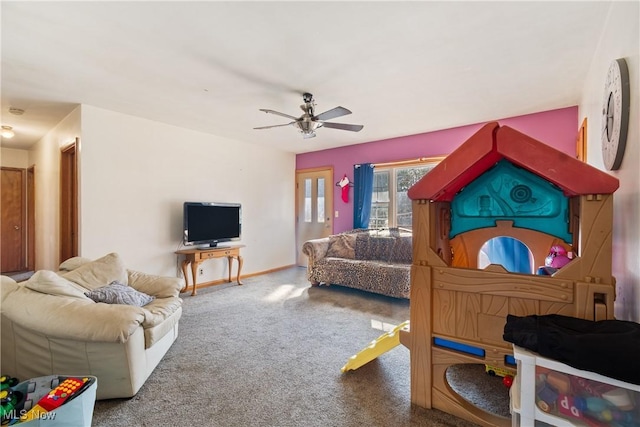 carpeted living room with baseboards and ceiling fan