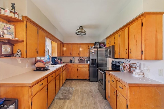 kitchen featuring light countertops, light wood-style flooring, appliances with stainless steel finishes, a sink, and open shelves
