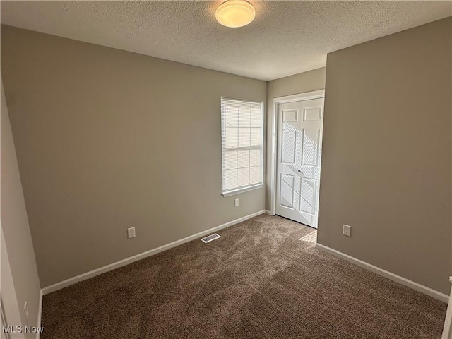 4225 E 93rd St, Cleveland, OH 44105 - unfurnished bedroom with carpet floors, baseboards, and a textured ceiling