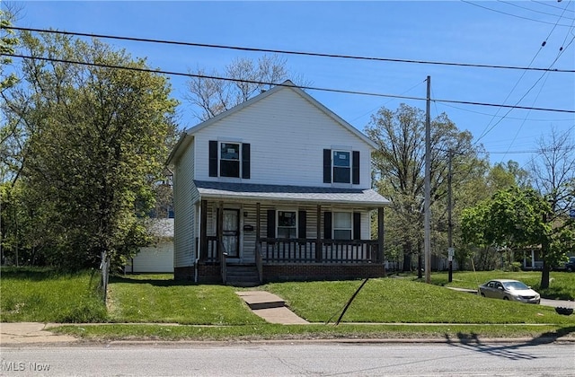 4225 E 93rd St, Cleveland, OH 44105 - view of front of property featuring covered porch and a front lawn