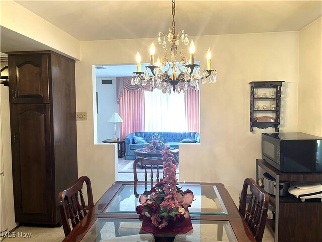 dining space with a notable chandelier and visible vents