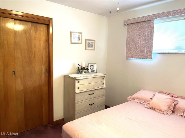bedroom with dark colored carpet