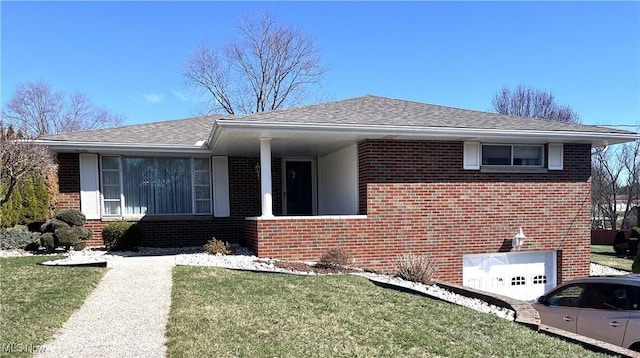 single story home featuring a shingled roof, a garage, a front lawn, and brick siding