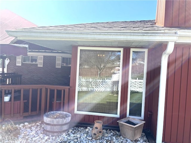 property entrance with a shingled roof