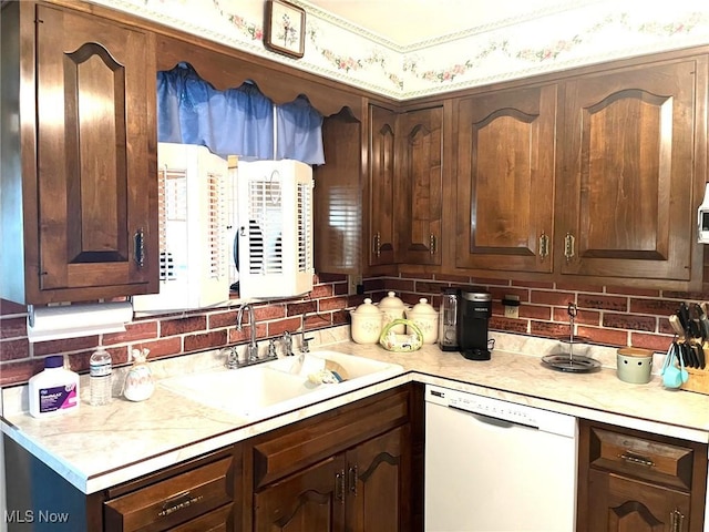 kitchen featuring a sink, dishwasher, light countertops, and dark brown cabinetry