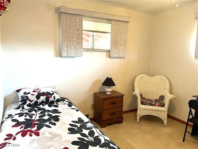bedroom with light carpet and baseboards