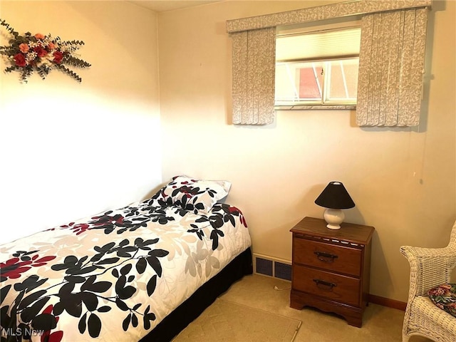 bedroom featuring visible vents and baseboards