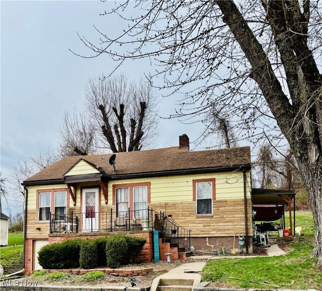 view of front of home with an attached garage and a chimney