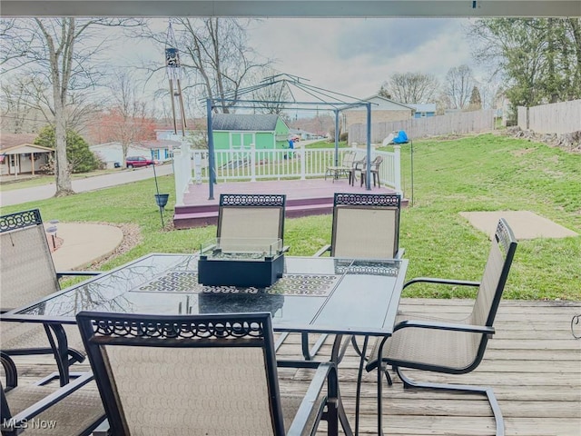 view of patio with outdoor dining space, a gazebo, a deck, and fence
