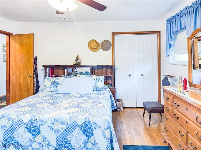 bedroom featuring a closet, wood finished floors, and a ceiling fan