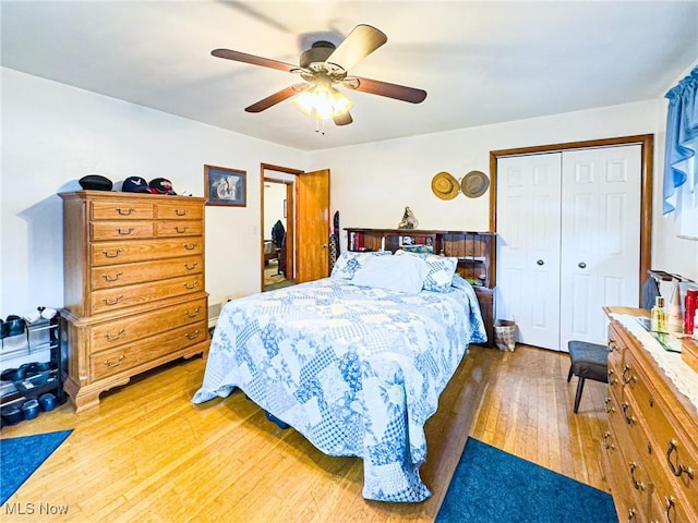 bedroom featuring a closet, light wood finished floors, and ceiling fan