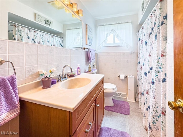 bathroom with a shower with curtain, vanity, tile walls, toilet, and visible vents