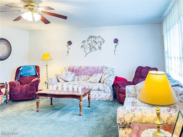 carpeted living area featuring ceiling fan