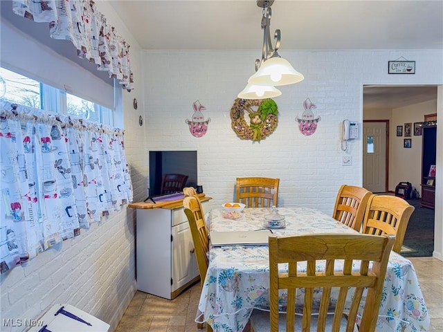 dining space with brick wall