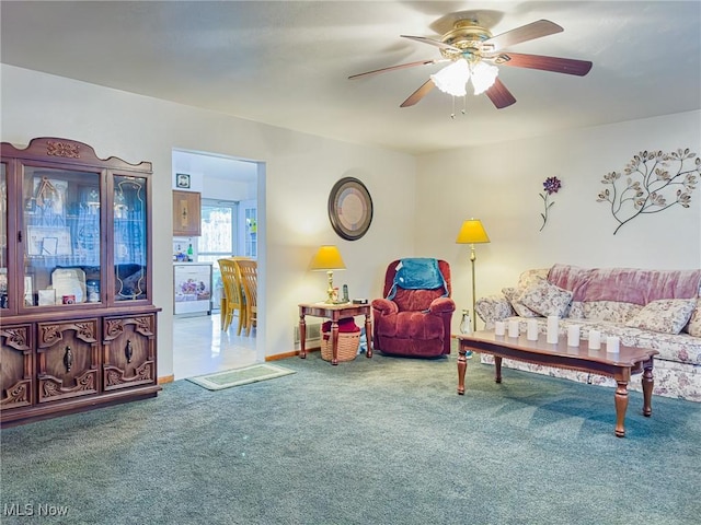 carpeted living area featuring ceiling fan
