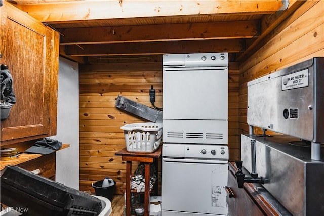 1000 Coon Fork Rd, Arnoldsburg, WV 25234 - kitchen with wooden walls, stacked washer / drying machine, and brown cabinets