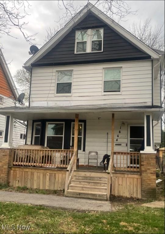 1444 E 135th St, East Cleveland, OH 44112 - american foursquare style home featuring a porch