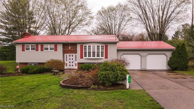 79 Windy Point Dr, Waterford, OH 45786 - raised ranch with driveway, a front yard, a chimney, an attached garage, and metal roof