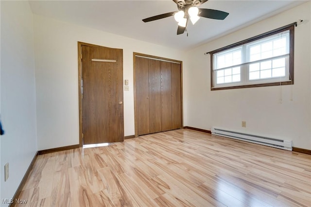 79 Windy Point Dr, Waterford, OH 45786 - unfurnished bedroom with baseboards, ceiling fan, light wood-style flooring, and a baseboard heating unit