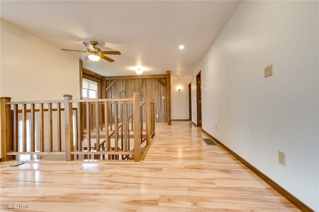 79 Windy Point Dr, Waterford, OH 45786 - hallway with baseboards, visible vents, wood finished floors, and an upstairs landing
