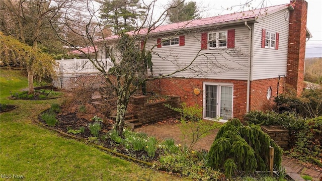 79 Windy Point Dr, Waterford, OH 45786 - rear view of house featuring a lawn and a chimney