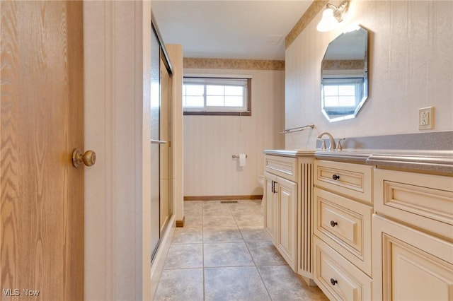 79 Windy Point Dr, Waterford, OH 45786 - full bath featuring tile patterned floors, vanity, a shower stall, and a wealth of natural light