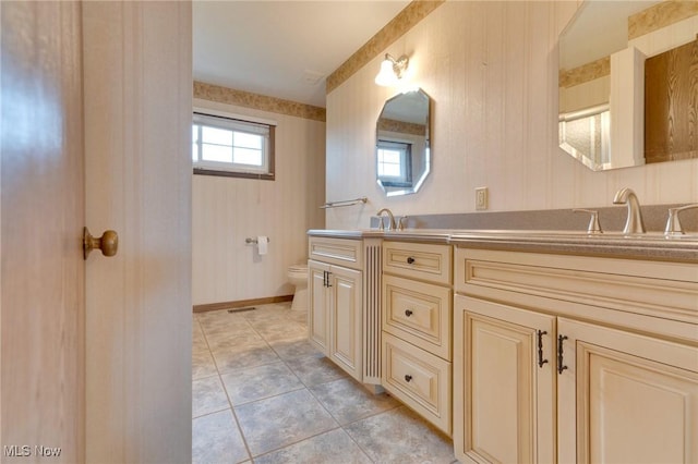 79 Windy Point Dr, Waterford, OH 45786 - full bath with tile patterned floors, toilet, a sink, baseboards, and double vanity