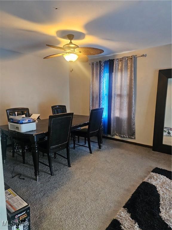 dining room featuring carpet flooring and a ceiling fan