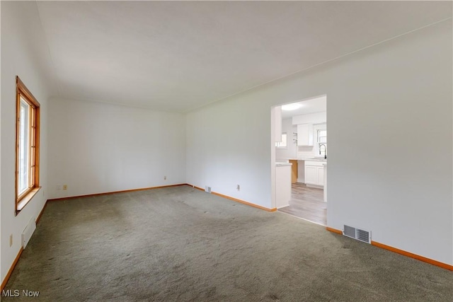 2955 Noel Dr, Youngstown, OH 44509 - unfurnished room with baseboards, visible vents, and light carpet
