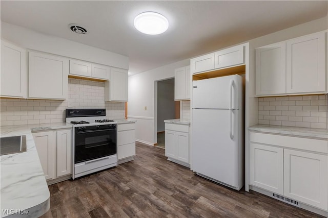 2955 Noel Dr, Youngstown, OH 44509 - kitchen featuring white cabinetry, range with gas stovetop, dark wood-type flooring, and freestanding refrigerator