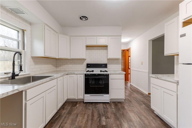 2955 Noel Dr, Youngstown, OH 44509 - kitchen featuring white cabinetry, white appliances, dark wood finished floors, a sink, and visible vents