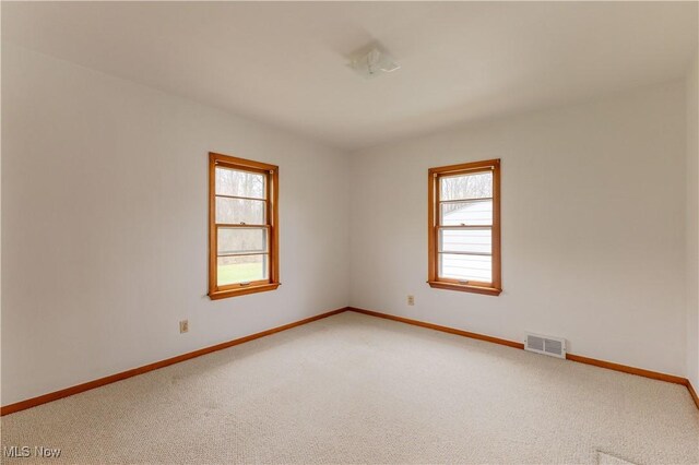 2955 Noel Dr, Youngstown, OH 44509 - spare room featuring baseboards, visible vents, and light colored carpet