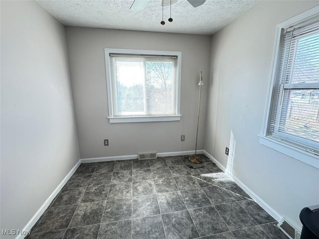 2106 17th St SW, Akron, OH 44314 - empty room featuring plenty of natural light, baseboards, visible vents, and ceiling fan