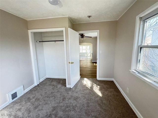 2106 17th St SW, Akron, OH 44314 - unfurnished bedroom featuring a closet, carpet flooring, a textured ceiling, visible vents, and baseboards