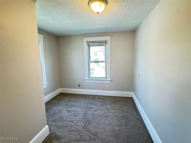 2106 17th St SW, Akron, OH 44314 - spare room with baseboards, carpet floors, and a textured ceiling