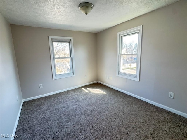 2106 17th St SW, Akron, OH 44314 - spare room with baseboards, carpet floors, and a textured ceiling