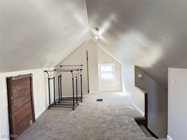 2106 17th St SW, Akron, OH 44314 - bonus room featuring baseboards, carpet floors, visible vents, and vaulted ceiling